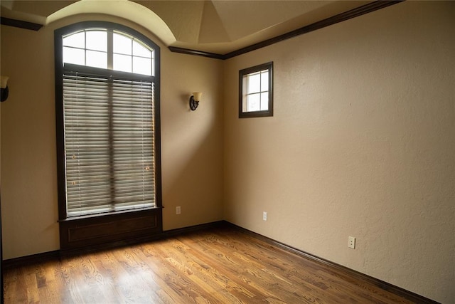 3176 E 146th Pl, Bixby, OK 74008 - spare room with wood finished floors, arched walkways, crown molding, and baseboards