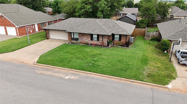 1913 Linwood St, Weatherford, OK 73096 - single story home featuring concrete driveway, central air condition unit, an attached garage, and brick siding