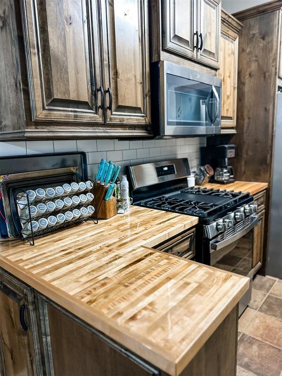 1913 Linwood St, Weatherford, OK 73096 - kitchen with wood counters and stainless steel appliances