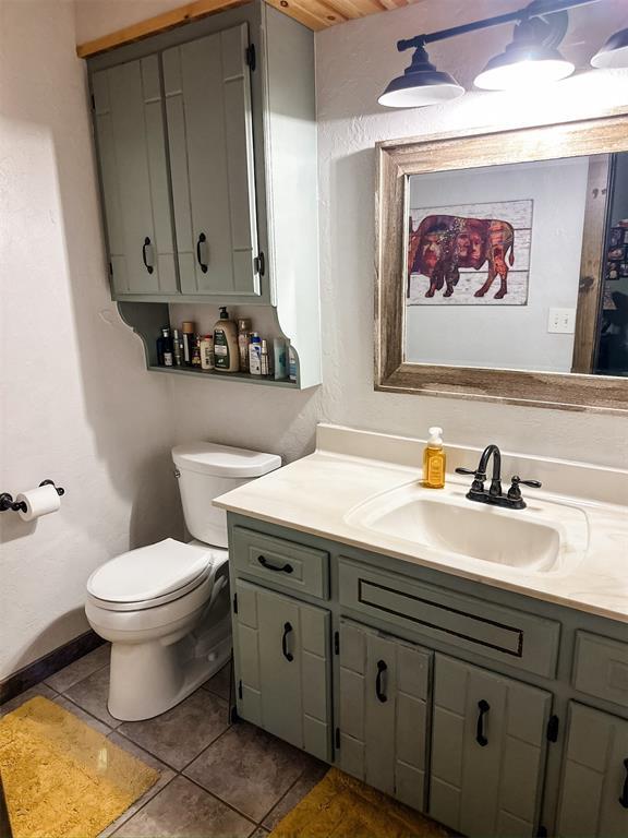 1913 Linwood St, Weatherford, OK 73096 - bathroom with vanity, toilet, and tile patterned floors
