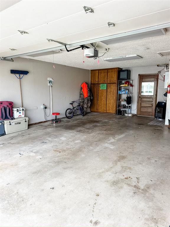 1913 Linwood St, Weatherford, OK 73096 - garage featuring a garage door opener