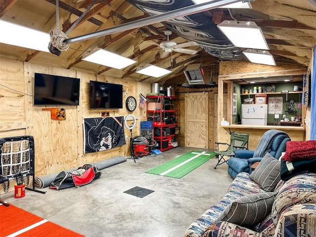1913 Linwood St, Weatherford, OK 73096 - recreation room featuring vaulted ceiling, concrete flooring, ceiling fan, and wood walls