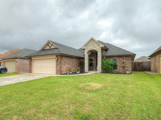 14512 Briarcliff St, Oklahoma City, OK 73170 - french country inspired facade featuring a garage, roof with shingles, driveway, and brick siding