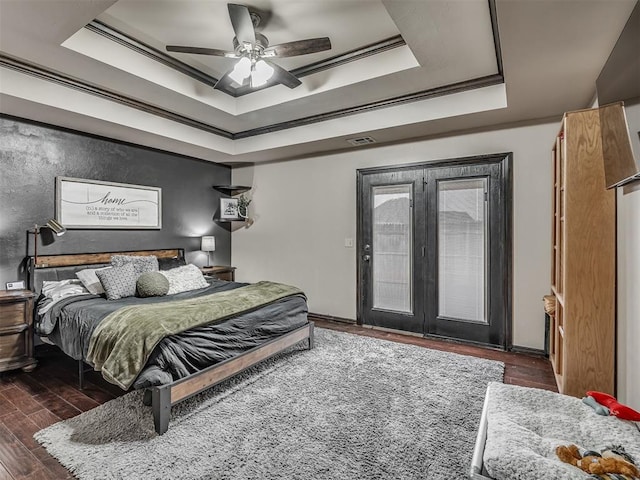 14512 Briarcliff St, Oklahoma City, OK 73170 - bedroom featuring a raised ceiling, ornamental molding, dark wood-type flooring, and a ceiling fan