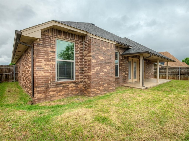 14512 Briarcliff St, Oklahoma City, OK 73170 - back of house featuring a patio area, brick siding, and a shingled roof