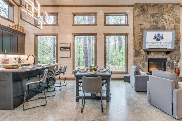 166 Morning Berry Trl, Broken Bow, OK 74728 - dining room with wooden walls and a fireplace