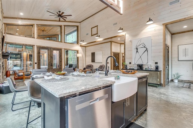 166 Morning Berry Trl, Broken Bow, OK 74728 - kitchen featuring dishwasher, wooden walls, open floor plan, a sink, and finished concrete flooring