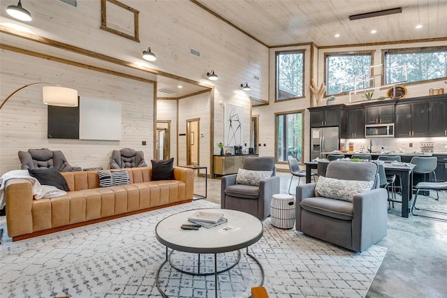 166 Morning Berry Trl, Broken Bow, OK 74728 - living room with a high ceiling, finished concrete flooring, wood walls, wood ceiling, and recessed lighting