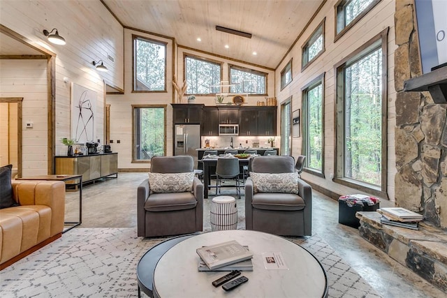 166 Morning Berry Trl, Broken Bow, OK 74728 - living area featuring healthy amount of natural light, wooden ceiling, high vaulted ceiling, wooden walls, and recessed lighting