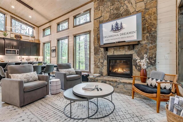 166 Morning Berry Trl, Broken Bow, OK 74728 - living area with wooden ceiling with exposed beams, high vaulted ceiling, a fireplace, and wooden walls