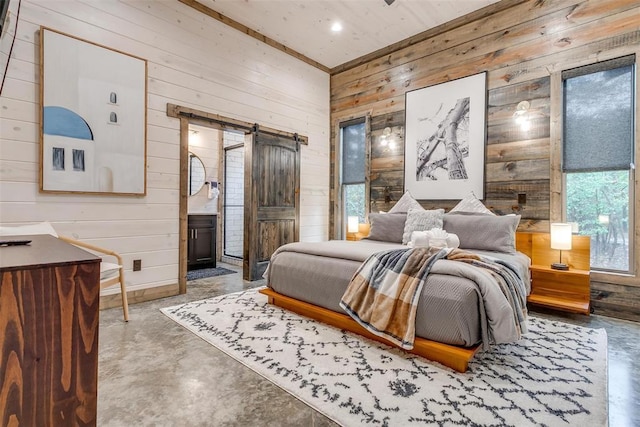 166 Morning Berry Trl, Broken Bow, OK 74728 - bedroom with a barn door, wood walls, and finished concrete flooring