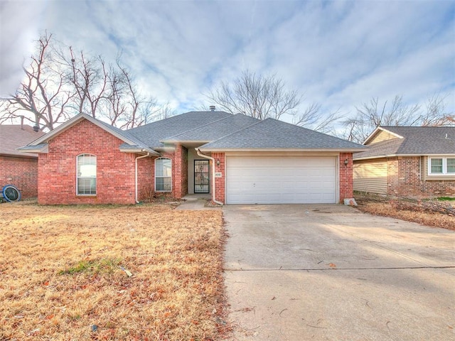 400 W 10th St, Edmond, OK 73003 - ranch-style house with a garage, driveway, brick siding, and a shingled roof