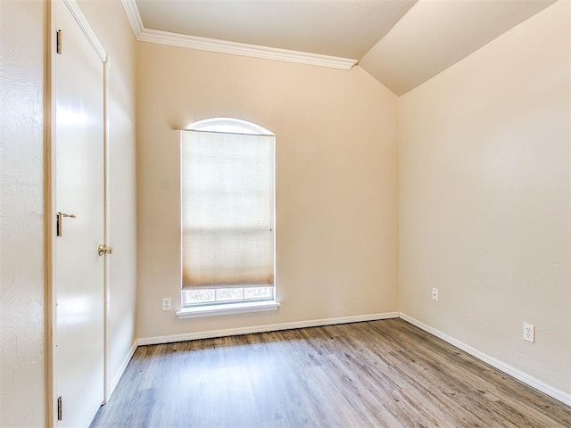 400 W 10th St, Edmond, OK 73003 - spare room with wood finished floors, plenty of natural light, baseboards, crown molding, and vaulted ceiling