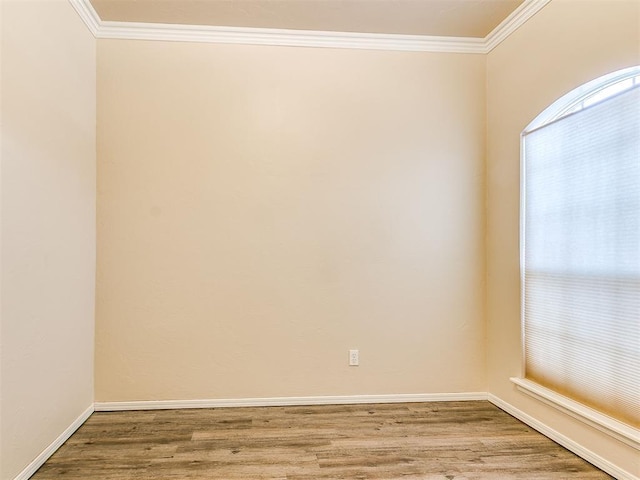 400 W 10th St, Edmond, OK 73003 - empty room featuring wood finished floors, ornamental molding, and baseboards