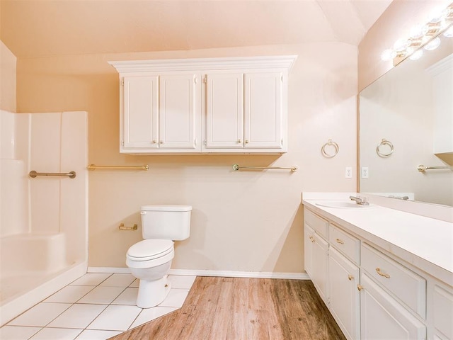 400 W 10th St, Edmond, OK 73003 - bathroom with vanity, baseboards, toilet, a shower, and vaulted ceiling