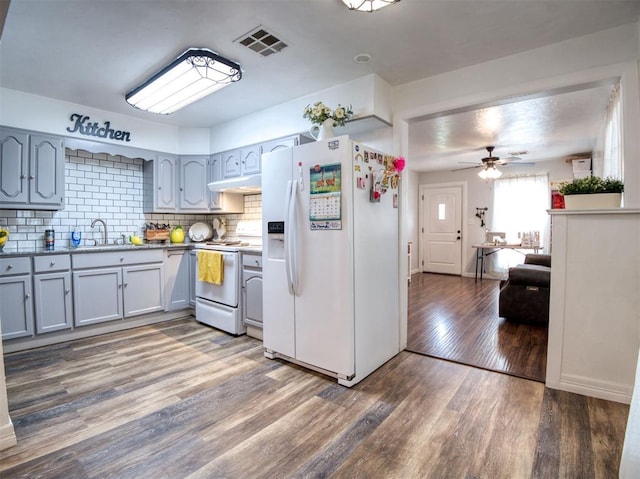 3109 SW 45th St, Oklahoma City, OK 73119 - kitchen with white appliances, a sink, wood finished floors, tasteful backsplash, and a ceiling fan
