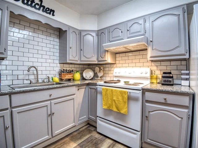 3109 SW 45th St, Oklahoma City, OK 73119 - kitchen with white electric stove, under cabinet range hood, a sink, dark wood-type flooring, and tasteful backsplash