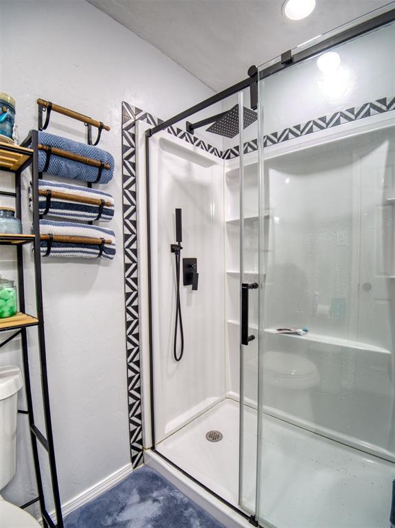3109 SW 45th St, Oklahoma City, OK 73119 - full bathroom with toilet, a shower stall, and baseboards