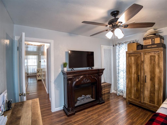 3109 SW 45th St, Oklahoma City, OK 73119 - living room featuring dark wood-style floors, a ceiling fan, and baseboards