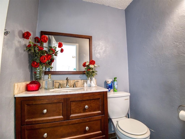 3109 SW 45th St, Oklahoma City, OK 73119 - bathroom with toilet, vanity, and a textured ceiling