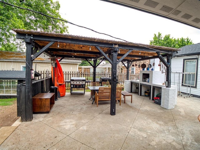 3109 SW 45th St, Oklahoma City, OK 73119 - view of patio featuring a fireplace, a gazebo, grilling area, and outdoor dining area