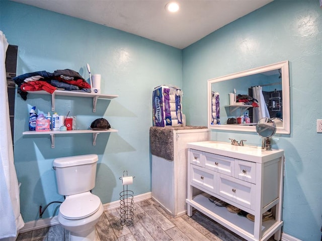 3109 SW 45th St, Oklahoma City, OK 73119 - full bathroom with vanity, toilet, wood finished floors, baseboards, and recessed lighting