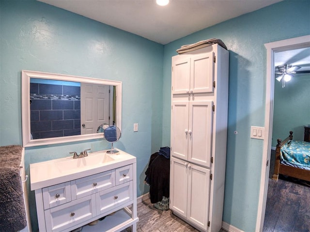 3109 SW 45th St, Oklahoma City, OK 73119 - bathroom with wood finished floors, vanity, ensuite bathroom, ceiling fan, and baseboards