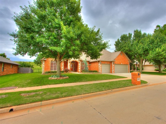 5608 NW 103rd St, Oklahoma City, OK 73162 - obstructed view of property with an attached garage, driveway, and brick siding