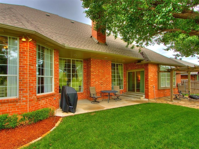 5608 NW 103rd St, Oklahoma City, OK 73162 - rear view of house with a chimney, a patio, brick siding, entry steps, and a shingled roof