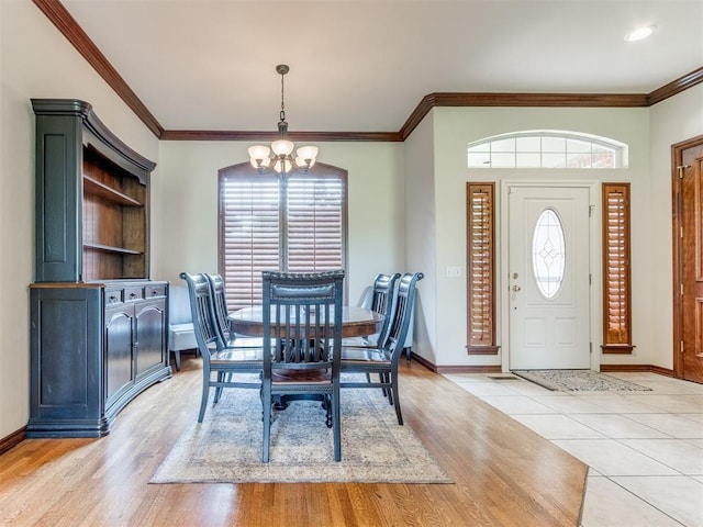5608 NW 103rd St, Oklahoma City, OK 73162 - dining room with a chandelier, ornamental molding, baseboards, and light wood-style floors