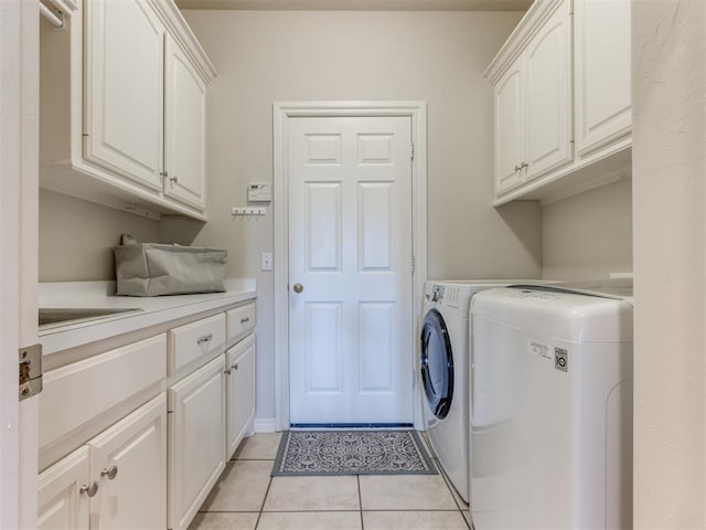 5608 NW 103rd St, Oklahoma City, OK 73162 - laundry room with cabinet space, independent washer and dryer, and light tile patterned floors