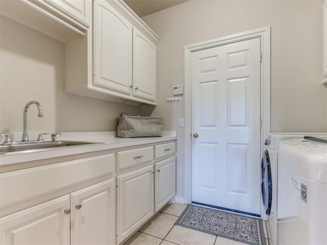 5608 NW 103rd St, Oklahoma City, OK 73162 - laundry area with cabinet space, independent washer and dryer, and light tile patterned floors