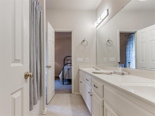 5608 NW 103rd St, Oklahoma City, OK 73162 - ensuite bathroom featuring double vanity, plenty of natural light, and baseboards