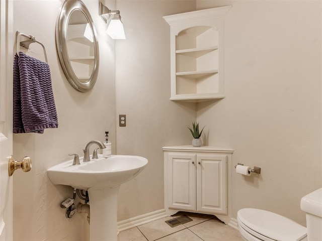 5608 NW 103rd St, Oklahoma City, OK 73162 - half bathroom featuring toilet, tile patterned floors, and baseboards