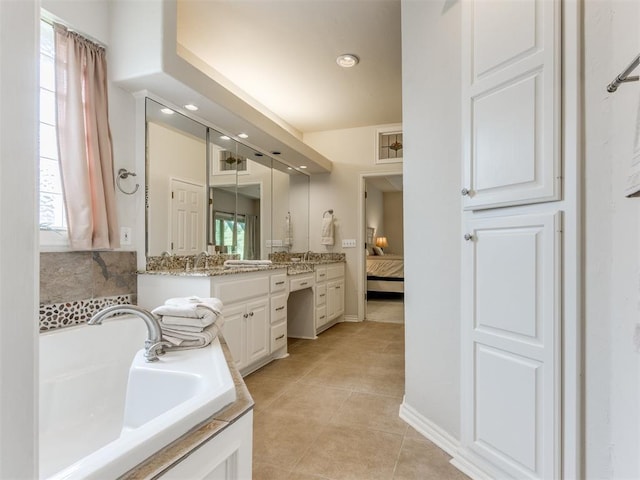 5608 NW 103rd St, Oklahoma City, OK 73162 - ensuite bathroom featuring vanity, a bath, tile patterned floors, and recessed lighting