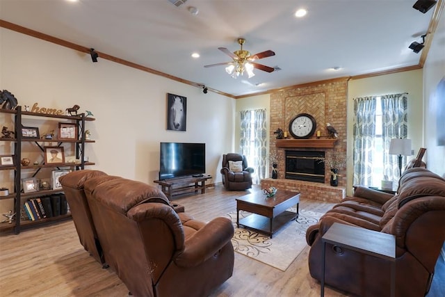 1811 N Bryan St, Shawnee, OK 74804 - living area featuring ornamental molding, a ceiling fan, a brick fireplace, light wood-type flooring, and recessed lighting