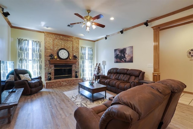 1811 N Bryan St, Shawnee, OK 74804 - living area with ceiling fan, ornamental molding, a fireplace, wood finished floors, and decorative columns
