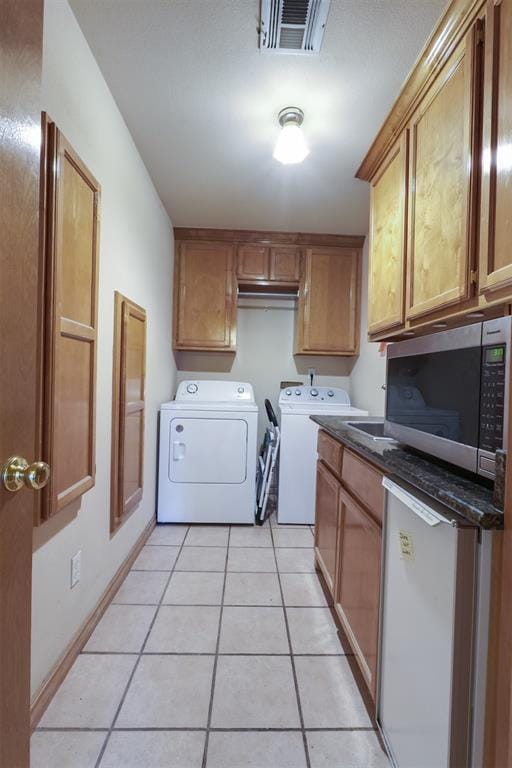 1811 N Bryan St, Shawnee, OK 74804 - laundry room featuring washer and clothes dryer and light tile patterned flooring