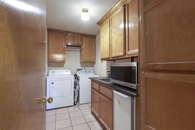 1811 N Bryan St, Shawnee, OK 74804 - laundry area featuring washing machine and dryer and light tile patterned floors