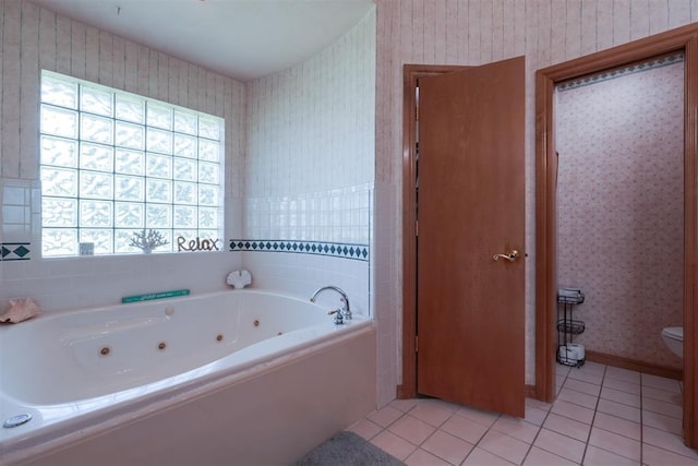 1811 N Bryan St, Shawnee, OK 74804 - bathroom featuring wallpapered walls, a tub with jets, tile patterned flooring, and toilet