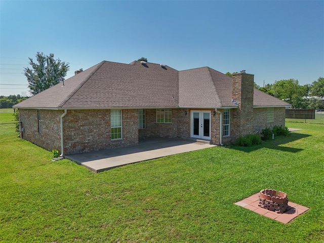 1811 N Bryan St, Shawnee, OK 74804 - rear view of house featuring a fire pit, french doors, a patio, and a chimney