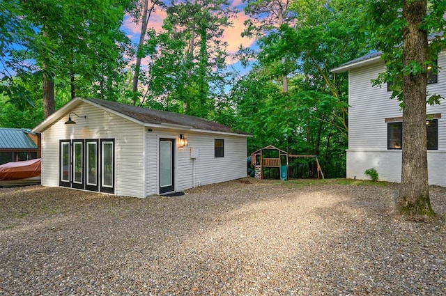 47 White Pine Rd, Broken Bow, OK 74728 - view of garage at dusk