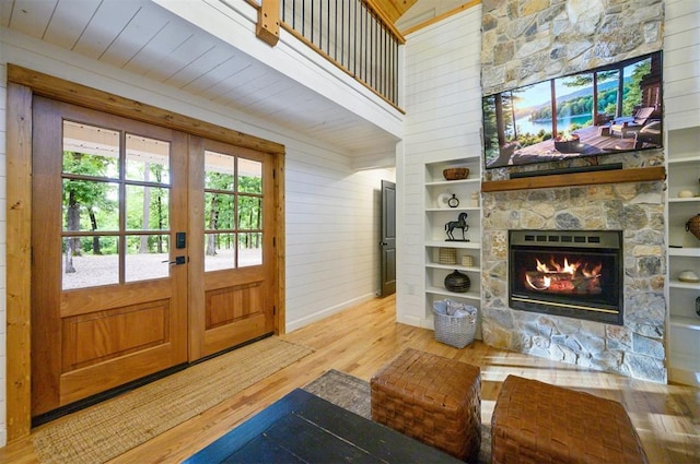 47 White Pine Rd, Broken Bow, OK 74728 - entrance foyer featuring wood finished floors, french doors, a fireplace, and wood walls