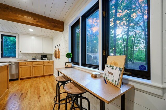 47 White Pine Rd, Broken Bow, OK 74728 - kitchen featuring stainless steel dishwasher, light wood finished floors, light countertops, and a wood ceiling with exposed beams