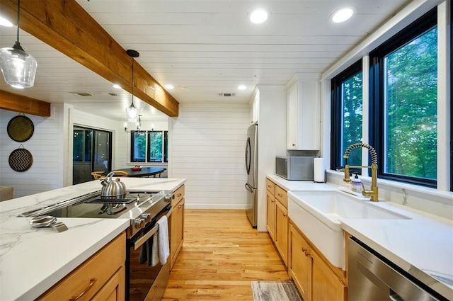 47 White Pine Rd, Broken Bow, OK 74728 - kitchen featuring stainless steel appliances, light wood finished floors, healthy amount of natural light, pendant lighting, and wood ceiling