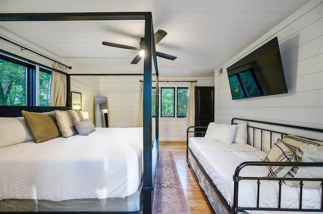 47 White Pine Rd, Broken Bow, OK 74728 - bedroom featuring multiple windows, wood finished floors, and wood walls