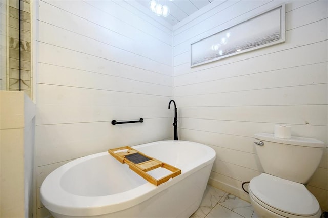 47 White Pine Rd, Broken Bow, OK 74728 - bathroom featuring a freestanding tub, marble finish floors, and wood walls