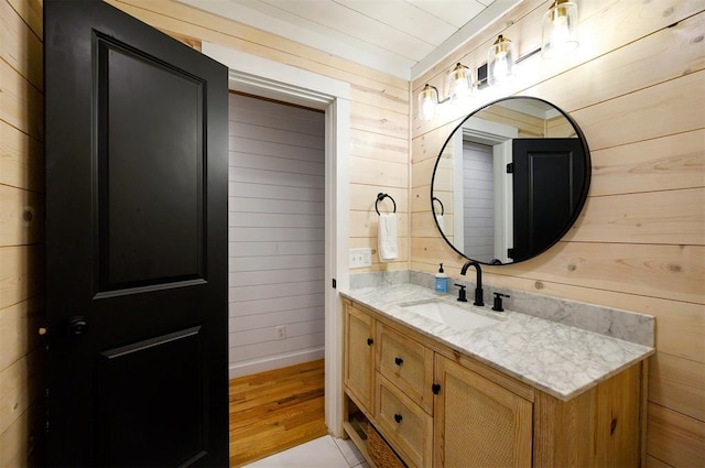 47 White Pine Rd, Broken Bow, OK 74728 - bathroom with wooden walls, vanity, and wood finished floors