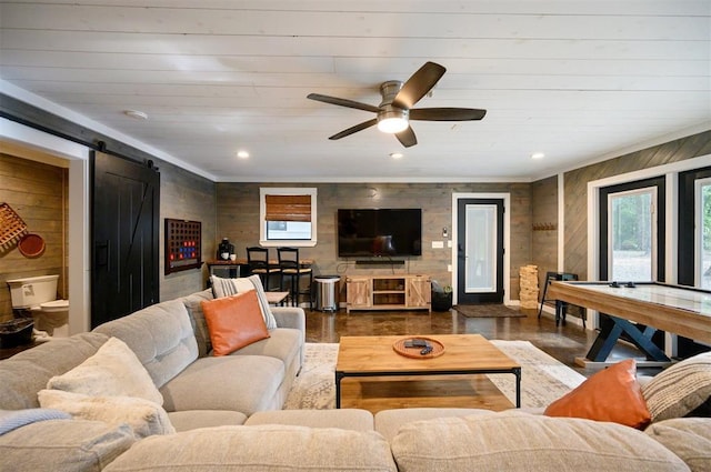 47 White Pine Rd, Broken Bow, OK 74728 - living area with a barn door, wooden walls, a ceiling fan, and recessed lighting