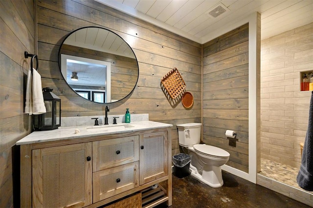 47 White Pine Rd, Broken Bow, OK 74728 - bathroom with vanity, concrete flooring, wooden walls, and tiled shower